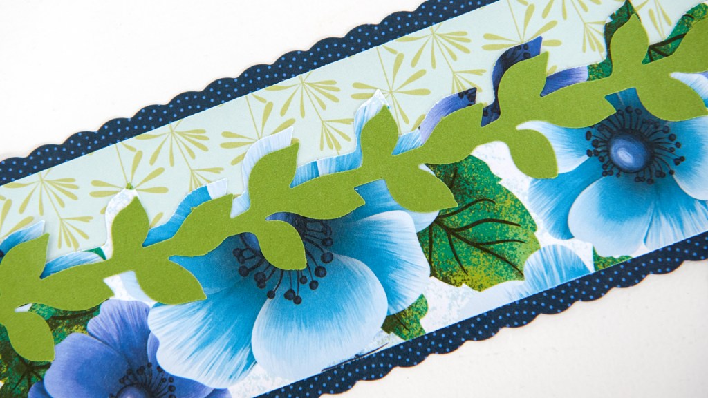 Closeup of a green and blue floral scrapbook border.