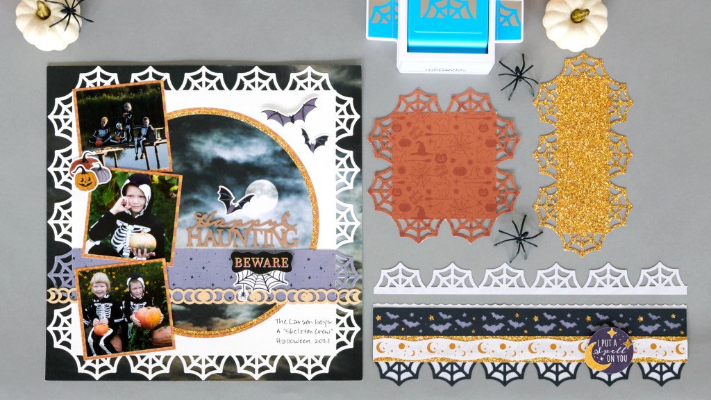 Spiderweb scrapbook layout with three photos and a spiderweb frame and a Halloween border with bats, stars, moons and spider webs punched out.