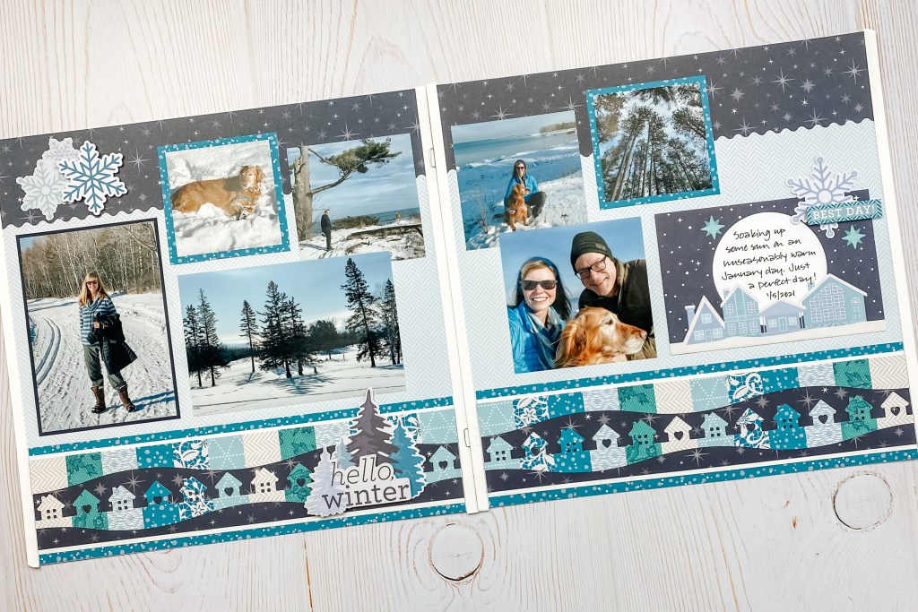 Winter-themed two-page spread with seven photos, a decorative border, journaling and snowflake embellishments.