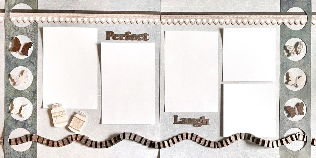 Two-page scrapbook spread with five photo placeholders, decorative borders and paper butterfly embellishments.