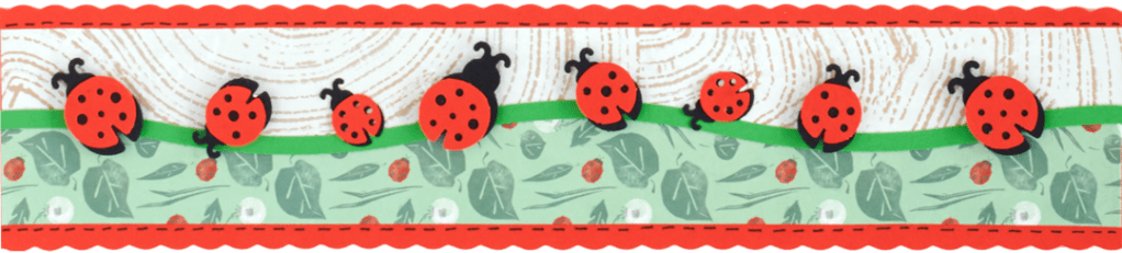 Ladybugs-themed horizontal scrapbook border with wavy patterned paper and ladybug punch cutouts.